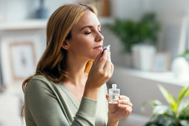 A woman Holding a Bottle of Essential Oils