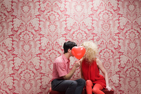 A Couple kissing holding a balloon. Johns Creek Love Spells