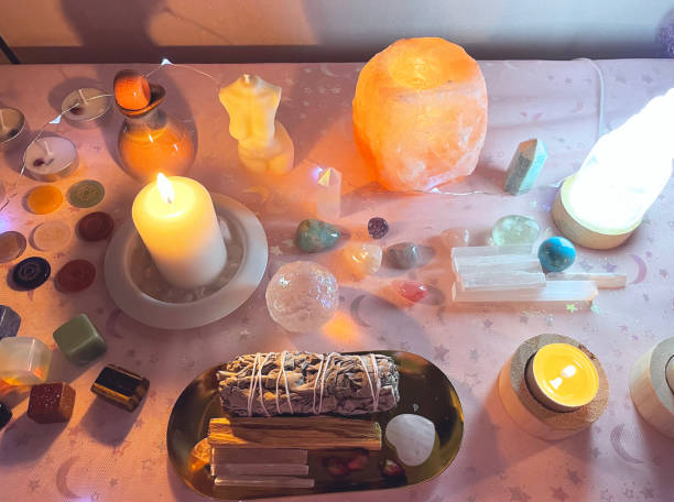 A full moon ritual setup with candles, crystals, and herbs for ancient love spells.