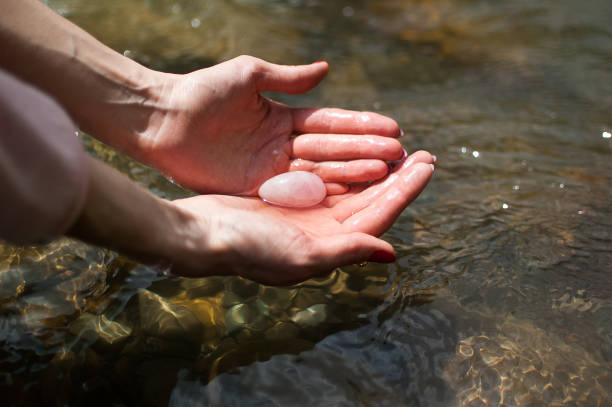 An egg in a man's palm cleaning with stream water. Best Love Spells in Sydney