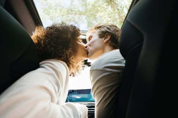 A Couple kissing in the front seat of a car. Best Love Spells in Sydney