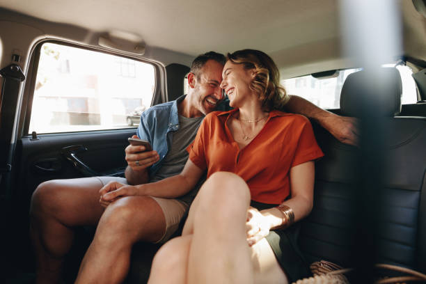 A Couple sitting in the back of a car. Love Spells