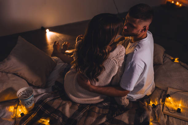 Essential Love Spells for Every Situation 13 A Couple sitting on bed. Love Spell Magic