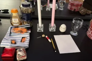 Reconciliation spell setup with white and pink candles honey and intention papers