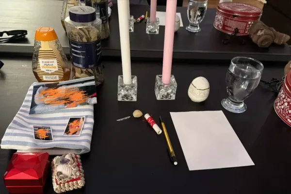 Reconciliation spell setup with white and pink candles honey and intention papers