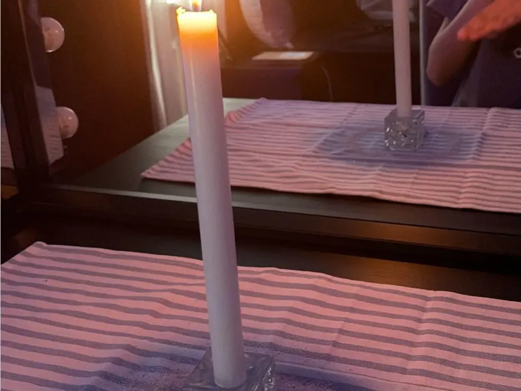 A traditional salt circle boundary and burning white candle used during a return to sender spell