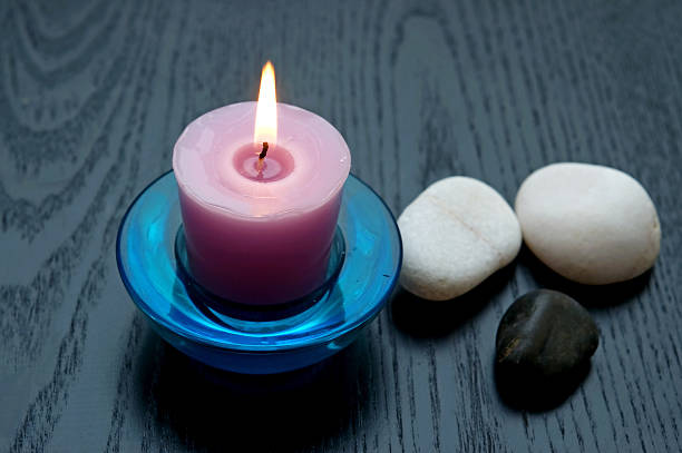 Crystals and a burning pink candle for Witchcraft spells
