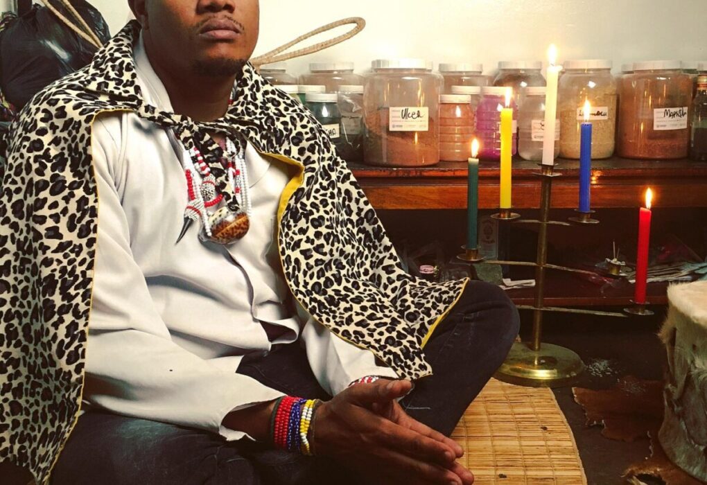 Lost Love Spell Caster sitting in a spiritual temple with candles burning