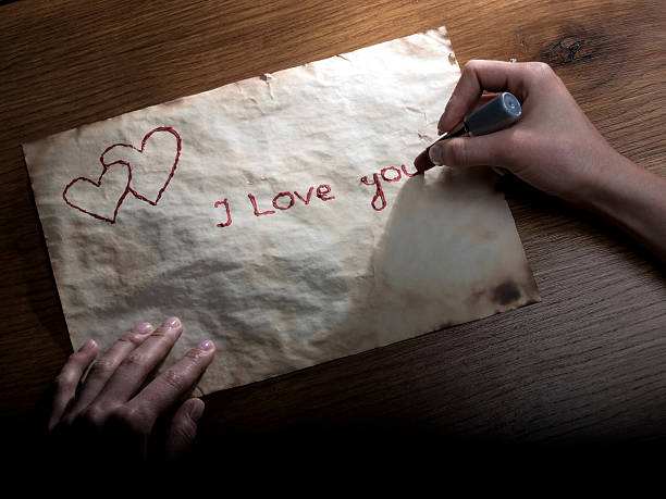 Hands writing love spell words on parchment under moonlight in Tehran