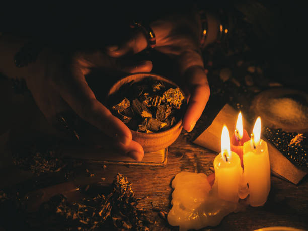 Isa Batha preparing ancient love spell with candles and herbs in Cairo