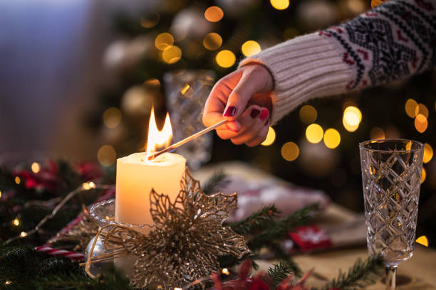 Woman lighting candle for easy love spell at home in Amman”