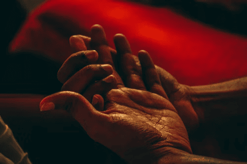 Hands performing soulmate manifestation spell with rose quartz in North Carolina