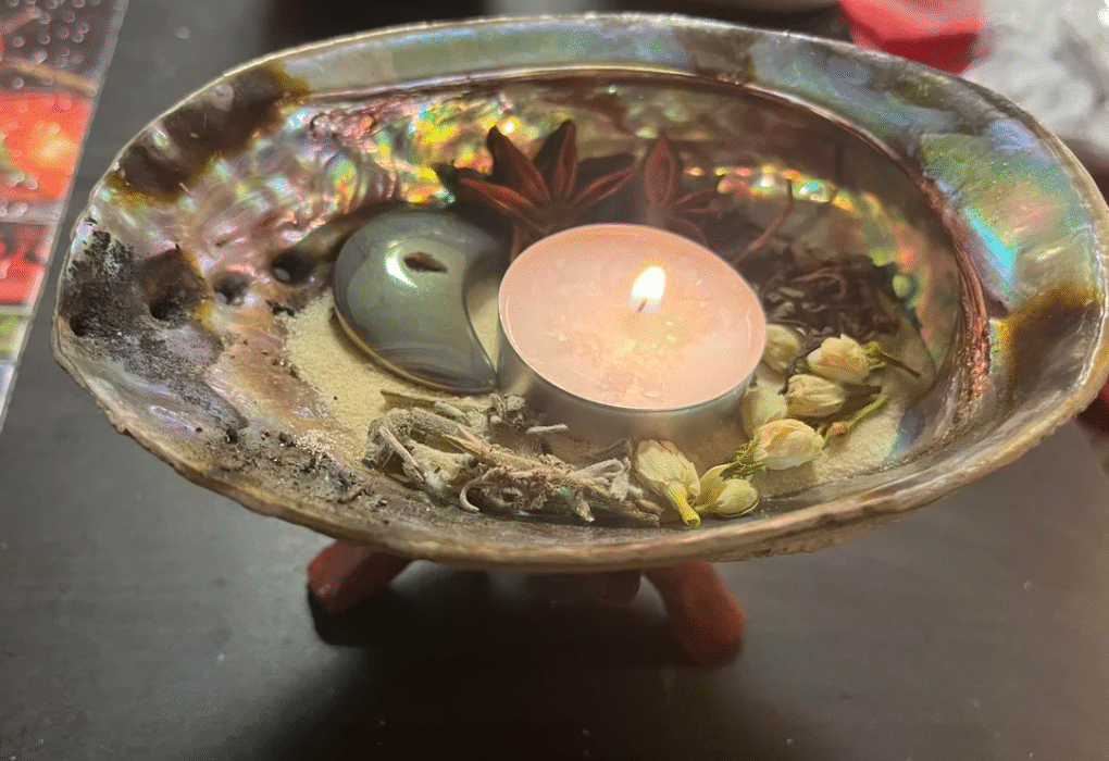 Ritual altar with candles and rose petals used for love spells in California by Batha