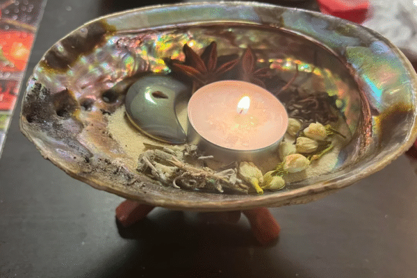 Ritual altar with candles and rose petals used for love spells in California by Batha