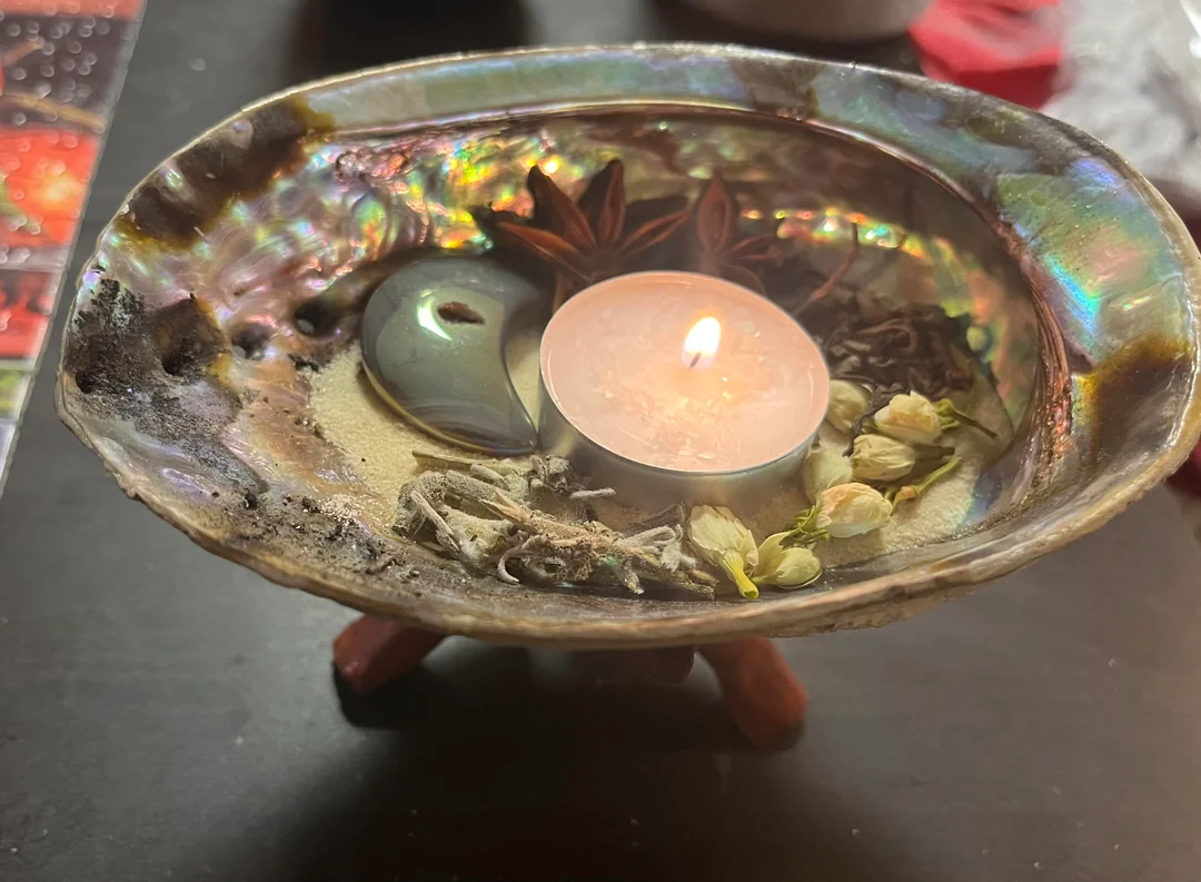Ritual altar with candles and rose petals used for love spells in California by Batha