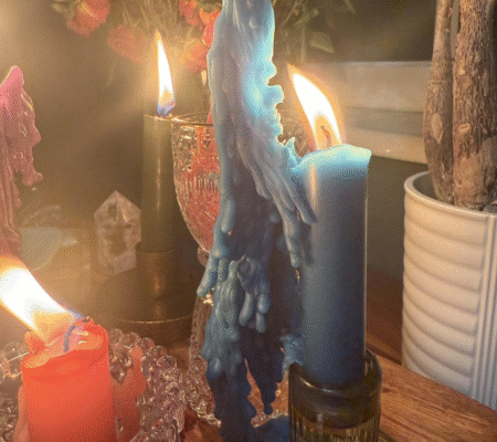 Caster Batha performing a bring back lost lover spell with candles and herbs