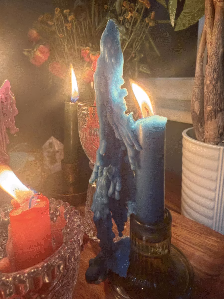 Caster Batha performing a bring back lost lover spell with candles and herbs