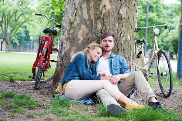 A couple sitting in a park after using Powerful Love Spells in Frankfurt by Batha