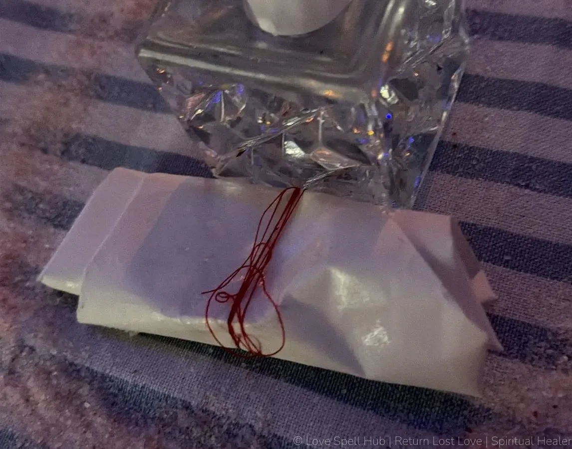 A folded petition paper secured inside a protective salt circle barrier for uncrossing rituals