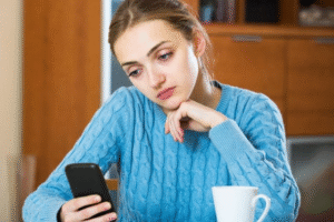 A Spell to Make Someone Text You Ritual Setup – Shows a candle, bay leaf, and phone for a communication spell.