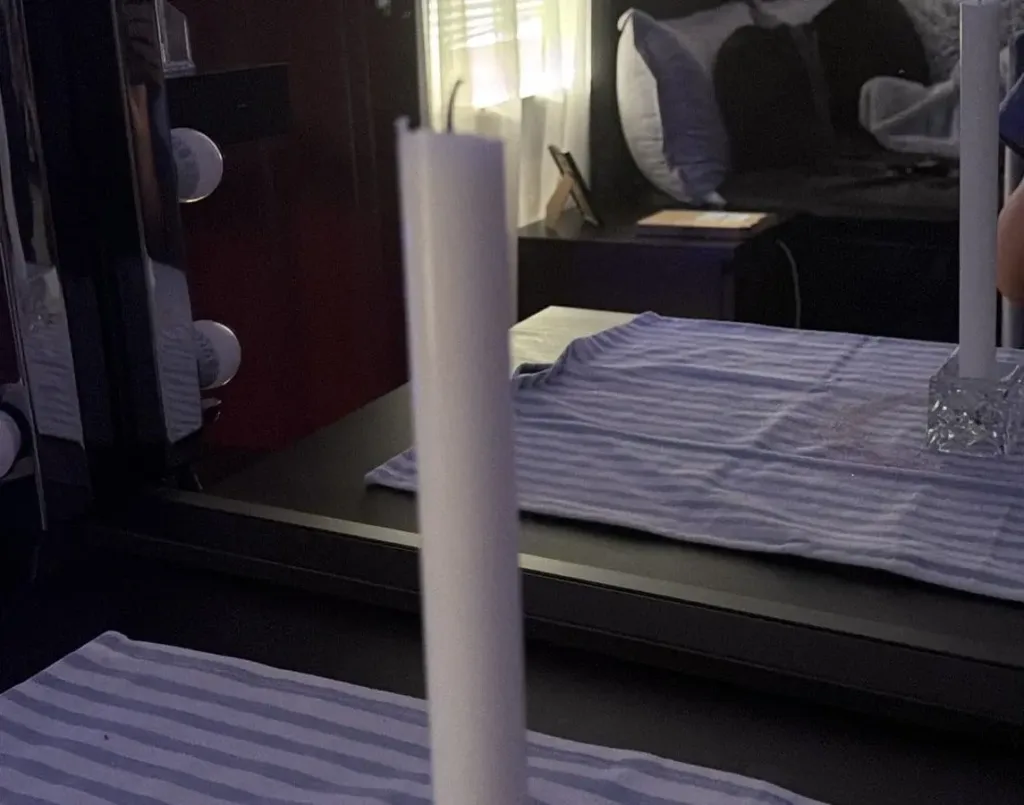 How to Get Witchcraft Off Me 4 A white candle on a glass holder and defensive mirror work used to compare witchcraft removal