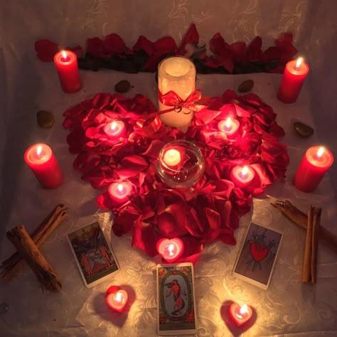 Red candle, honey jar, rose petals, licorice root, and petition paper arranged on a ritual altar
