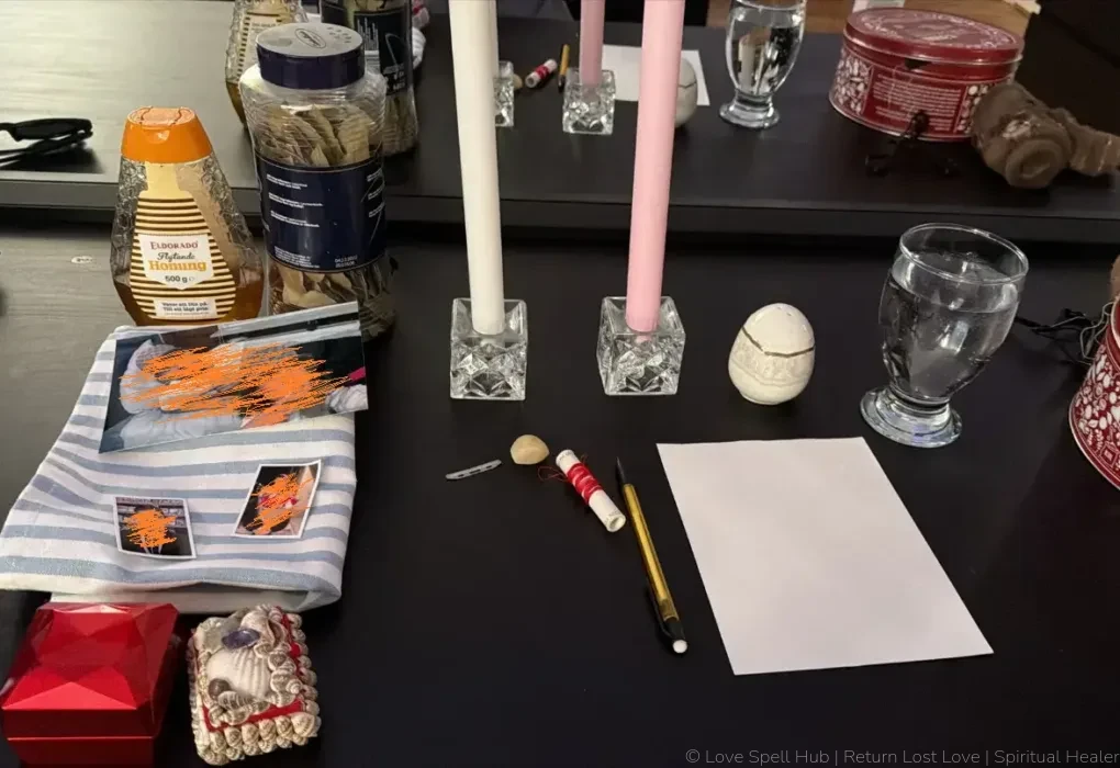 A traditional shrine altar setup with pink and white candles used for commitment spells