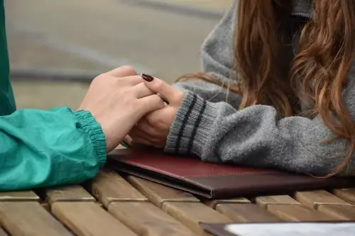 Commitment Spells: Complete Guide to Relationship Stability 5 A happy young couple holding hands open over an altar cloth to track commitment progress
