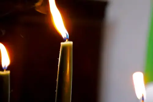 Dream Job Spell: Rituals to Manifest the Right Career 5 Green candle dream job spell beside written career goals and professional skills