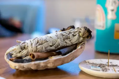 Sage beside a written intention for a fast job spell for someone else